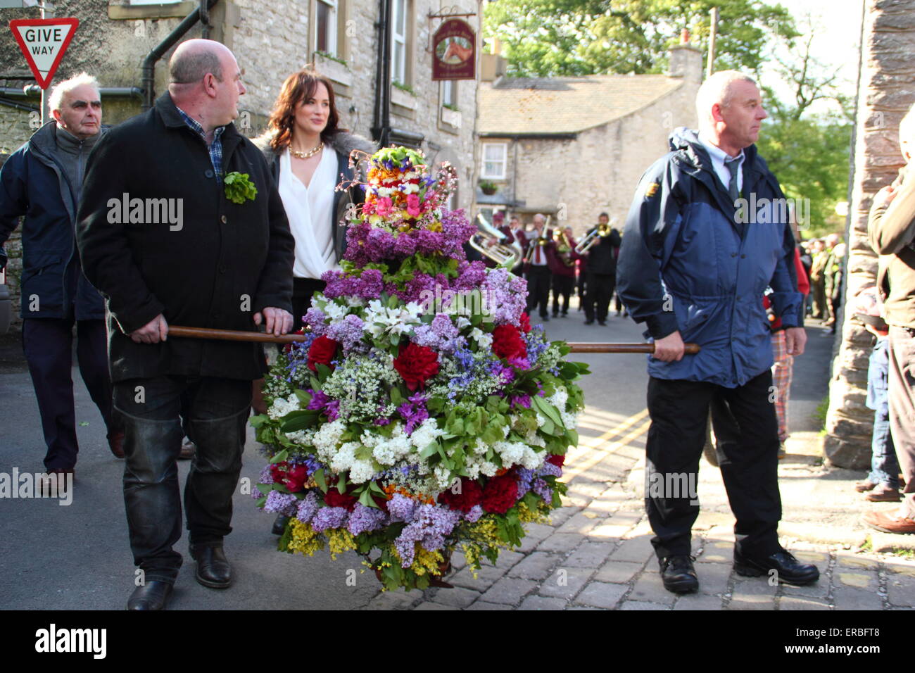 A floral headdress is paraded through the streets of Castleton ...