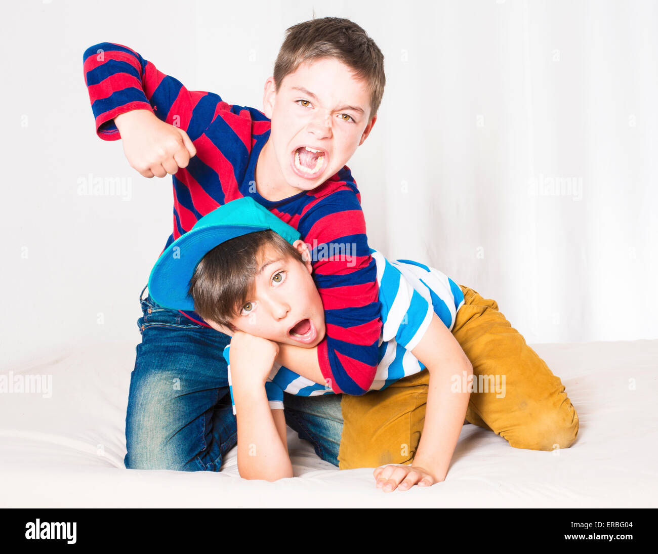 two young boys in bed and fighting Stock Photo Alamy