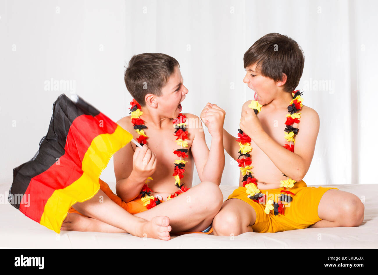 two boys with the german flag are watching a game and totally excited Stock Photo