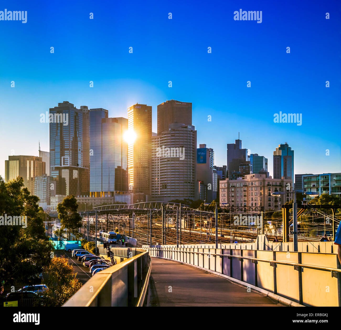 Walkway leading down to Richmond Railway station, with city skyscrapers at sunset Melbourne, Australia Stock Photo