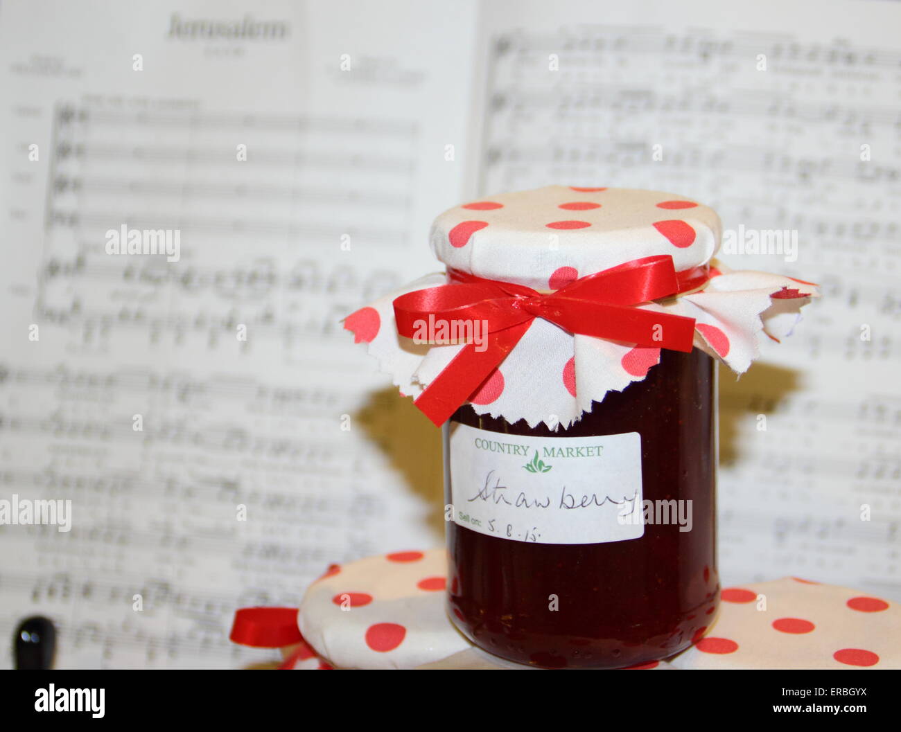 Home-made strawberry jam and the music score, Jerusalem on display at a church flower festival nods to the Women's Institute, UK Stock Photo