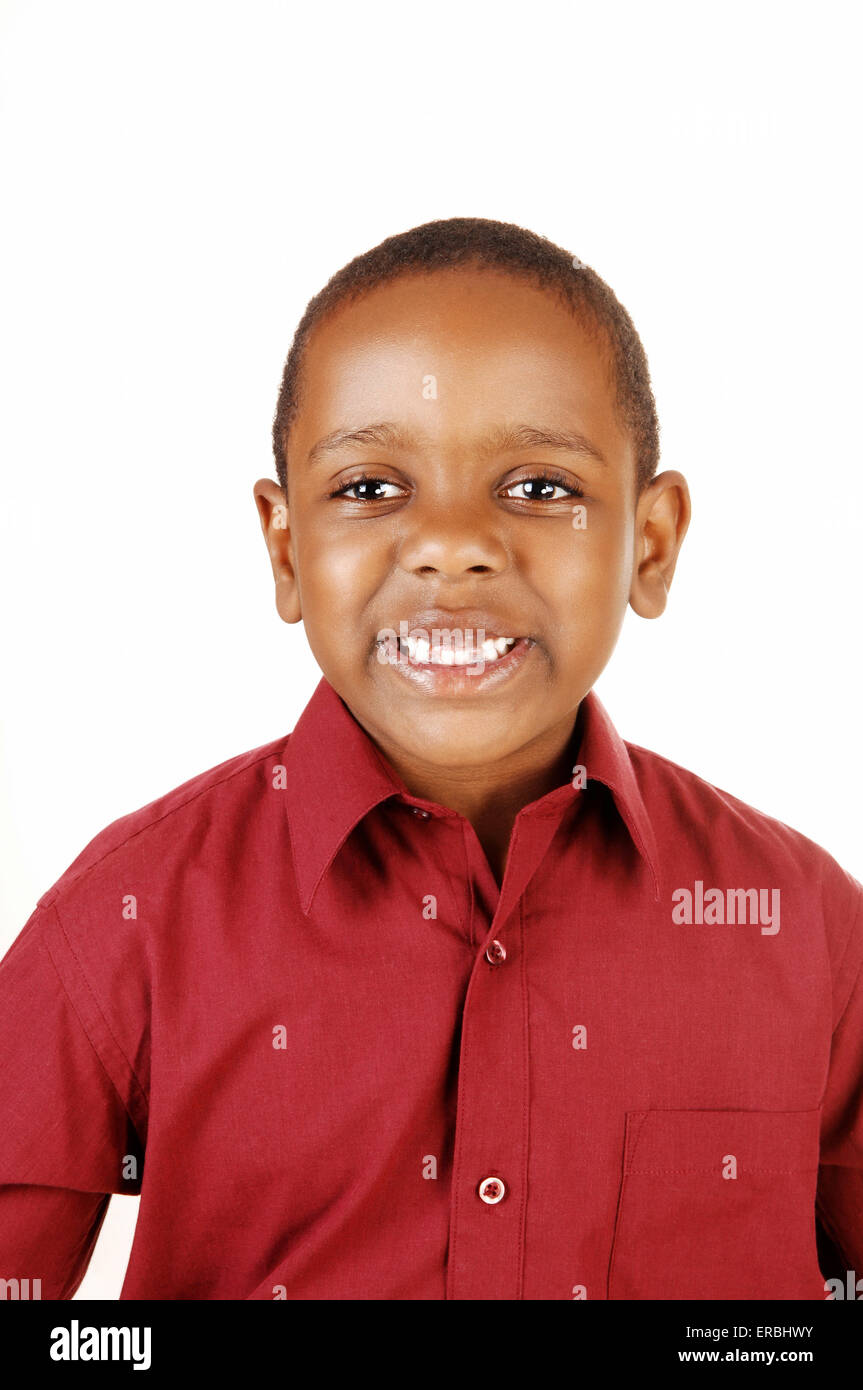 A portrait picture of an young African American boy in a red dress shirt with 3 missing tooth, for white background. Stock Photo