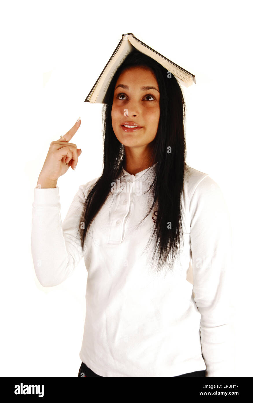 A lovely teenage girl in her school uniform with a book on top of her ...