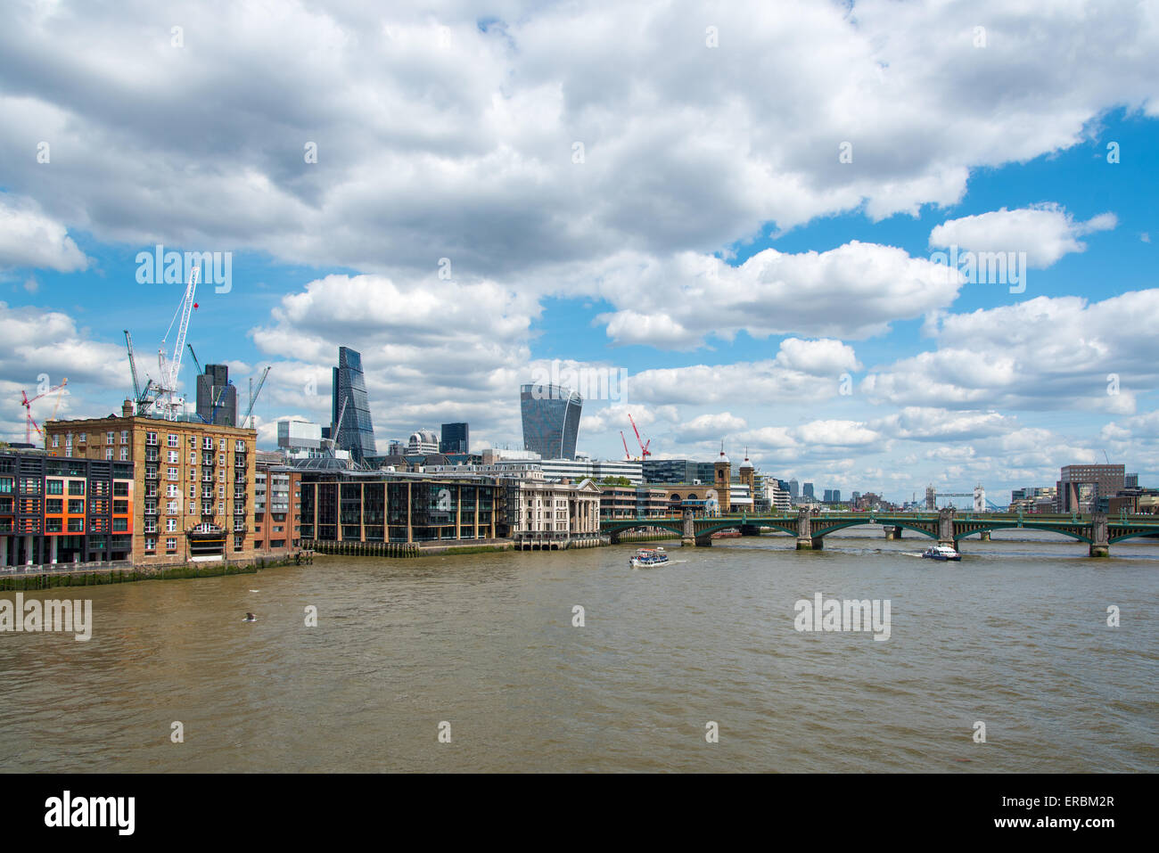 The North Bank of the River Thames, London.  Seen from the Millenium Bridge and looking towards the City and Southwark Bridge. Stock Photo