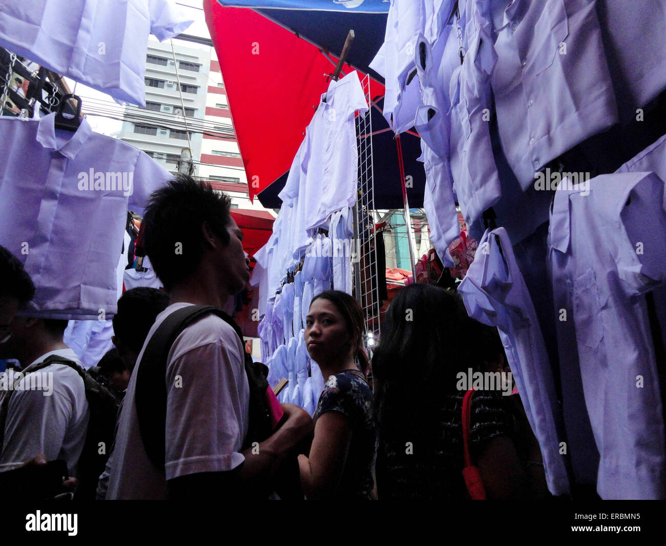 Manila, Philippines. 31st May, 2015. Shoppers pass by school uniforms being sold by vendors in Divisoria Market. Demand for school supplies has increased as the first day of school nears, which starts on June 1, 2015. © Richard James Mendoza/Pacific Press/Alamy Live News Stock Photo