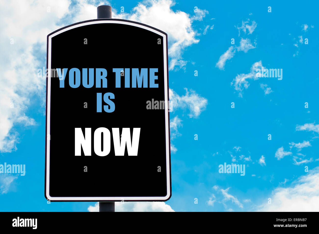 YOUR TIME IS NOW written on road sign isolated over clear blue sky
