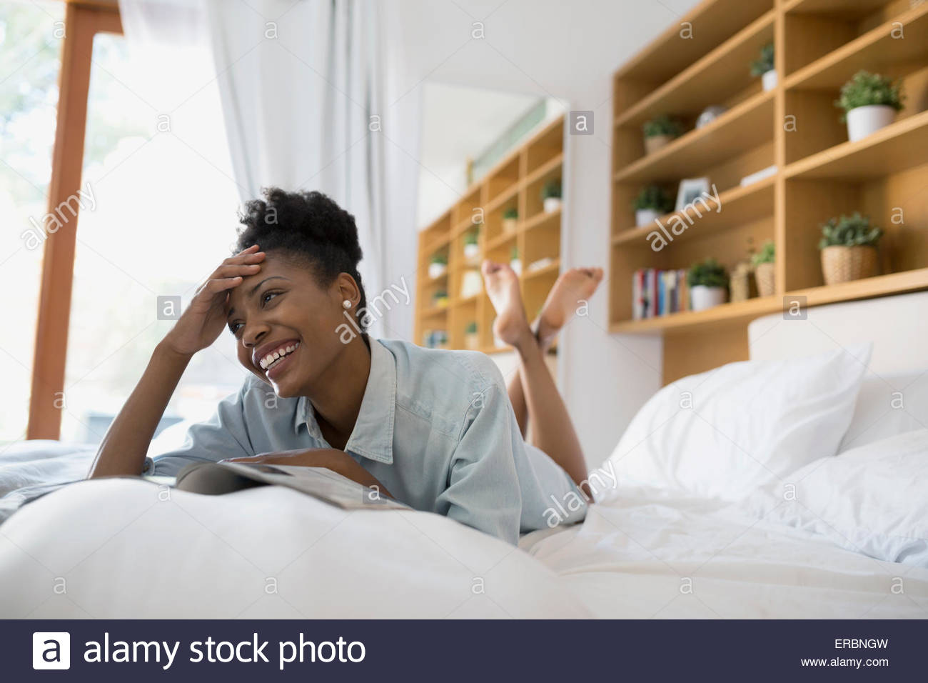 Woman reading magazine bed hires stock photography and images Alamy