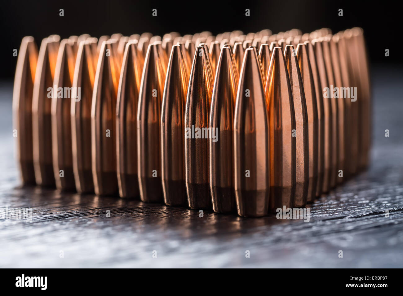 Macro shot of copper bullets that are in many rows to form a tri Stock