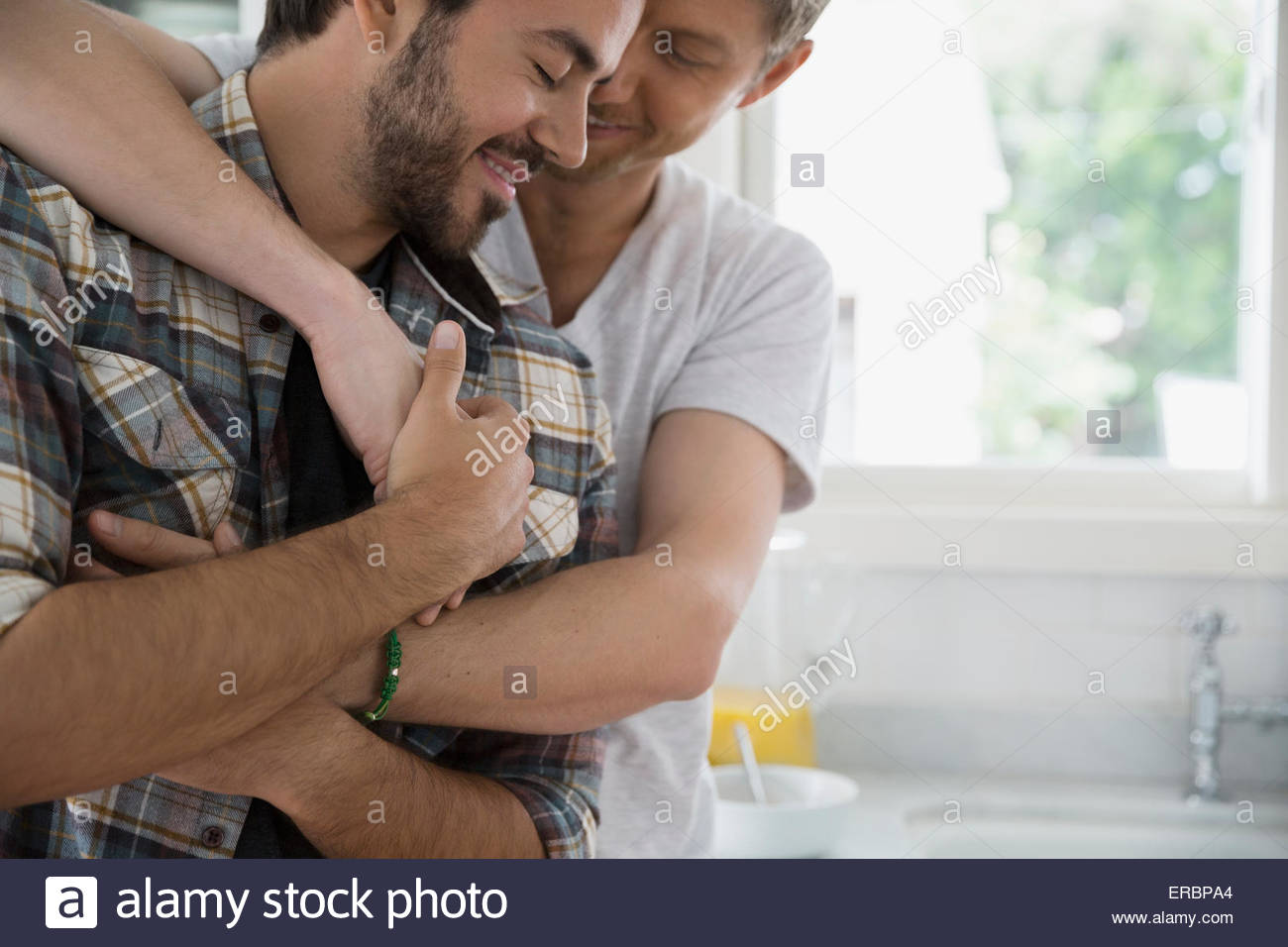 Close up affectionate homosexual couple hugging Stock Photo
