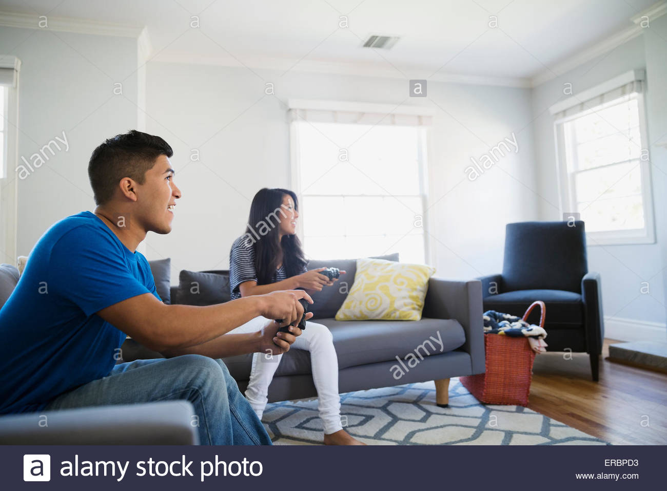 Teenage brother and sister playing video game Stock Photo
