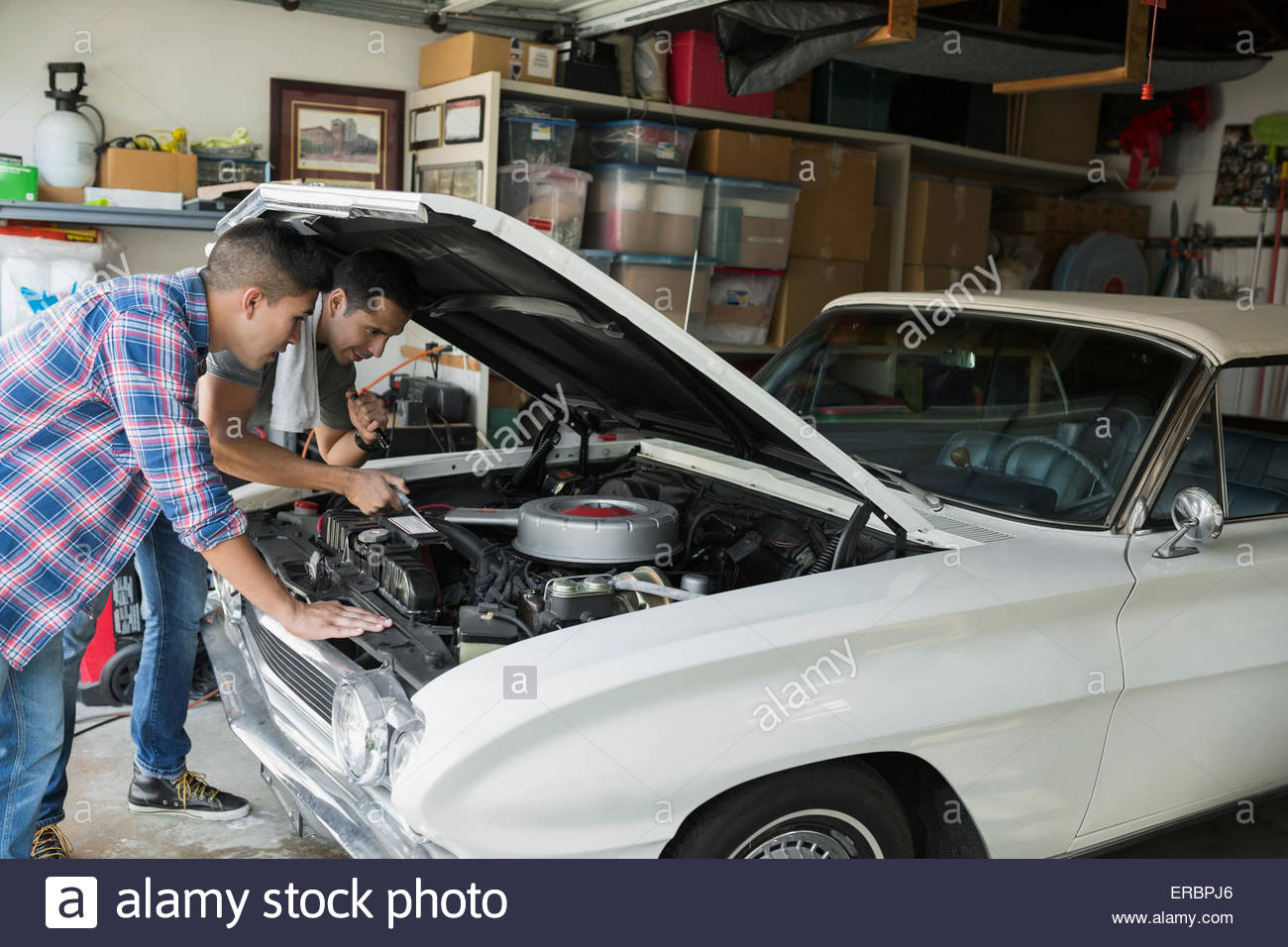 Father and son restoring vintage car engine garage Stock Photo Alamy