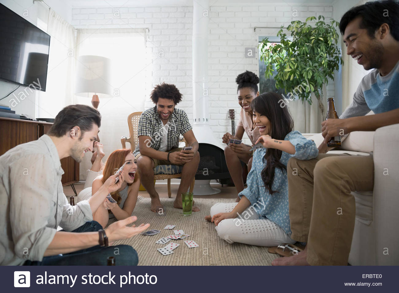 Friends hanging out playing cards in living room Stock Photo Alamy
