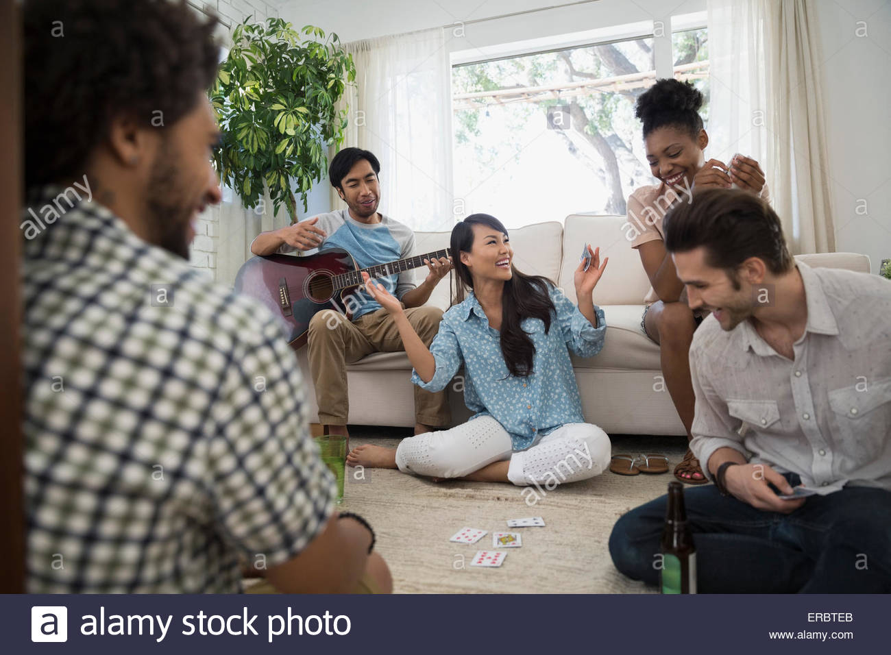 Friends hanging out playing cards in living room Stock Photo Alamy
