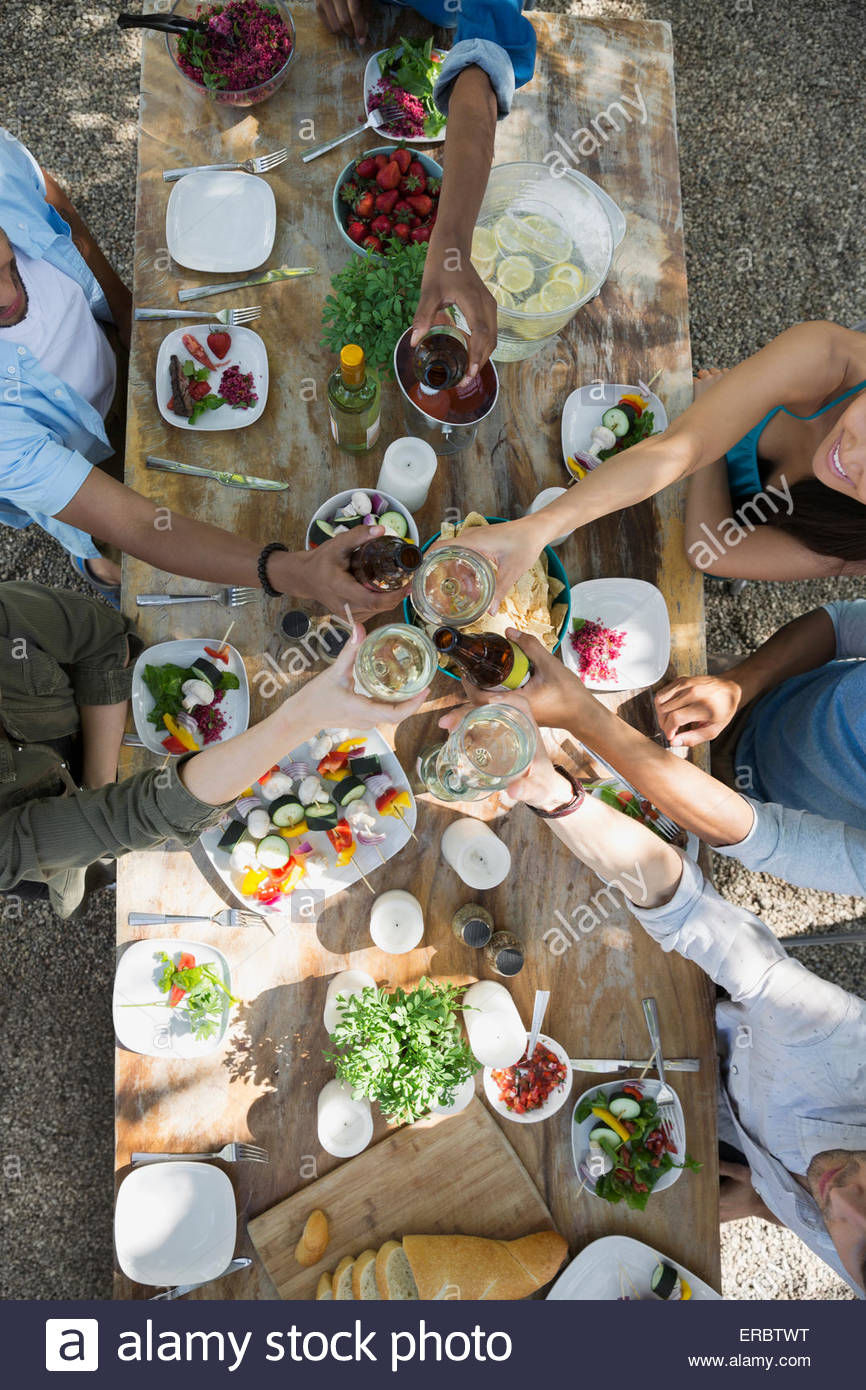 Overhead view friends toasting wine glasses patio table Stock Photo Alamy