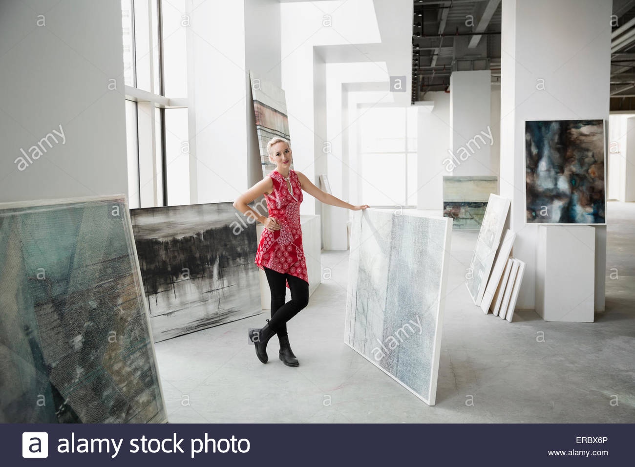 Portrait art dealer with painting in art gallery Stock Photo Alamy
