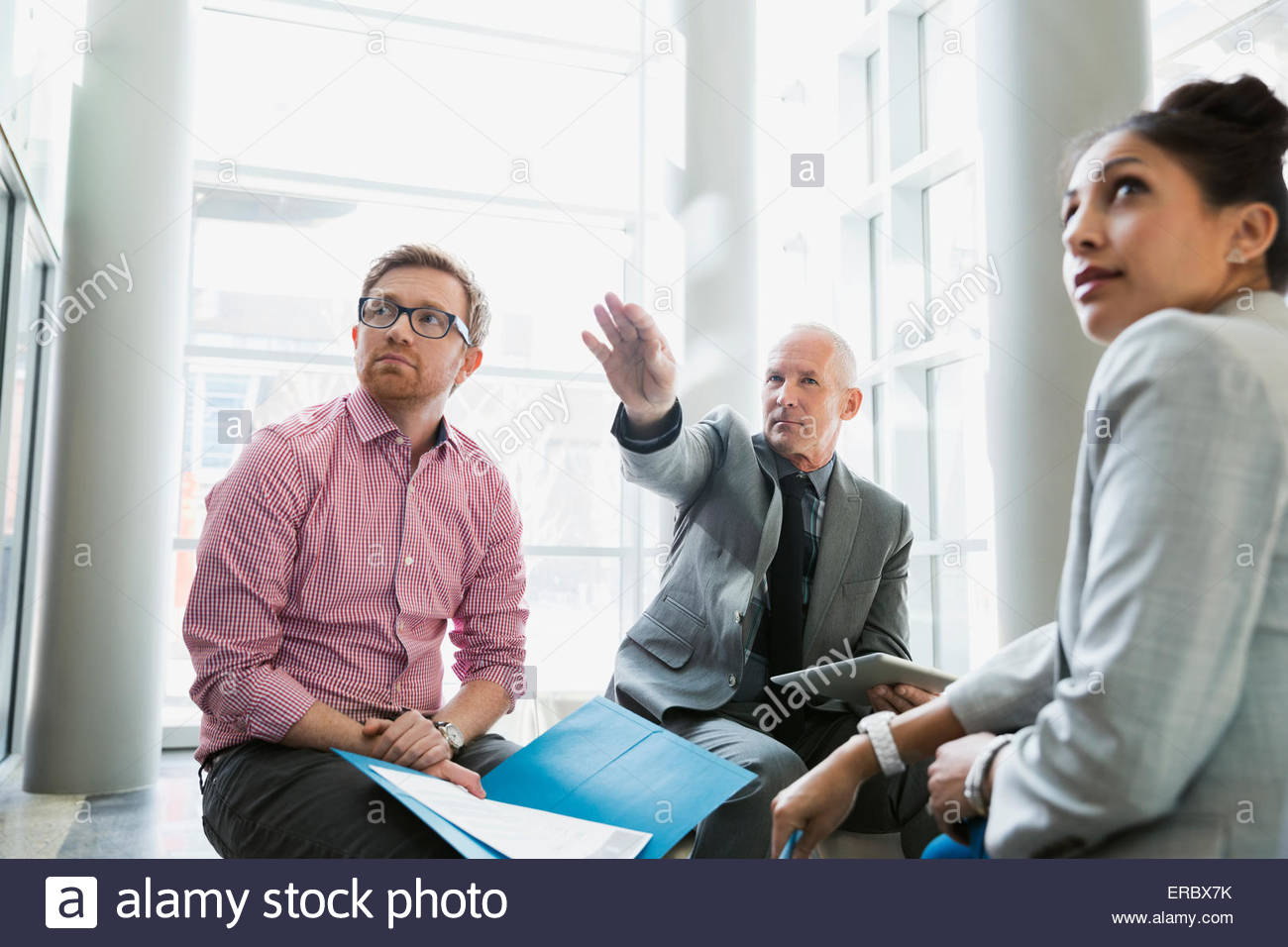 Business people meeting in lobby Stock Photo
