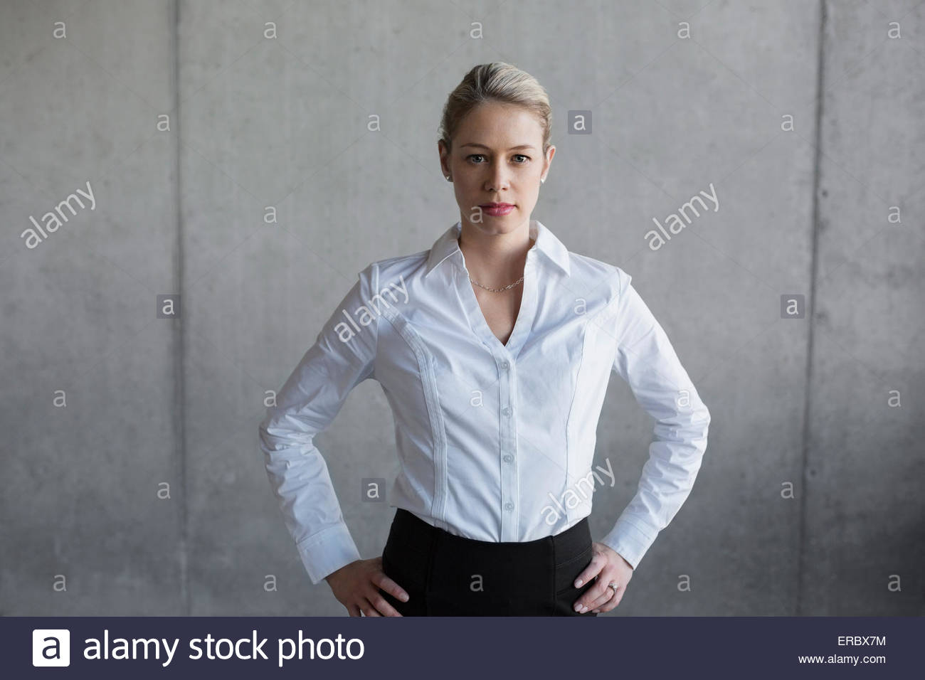 Portrait of confident businesswoman with hands on hips Stock Photo