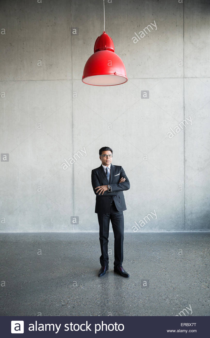 Portrait serious businessman under red lamp Stock Photo