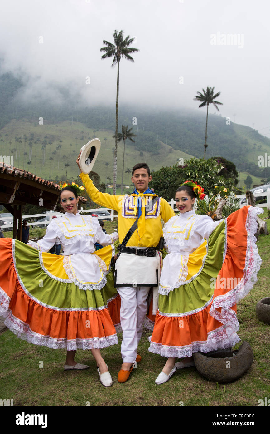 Three young Colombian folkloric dancers posing outside a restaurant in Salento, Colombia Stock Photo