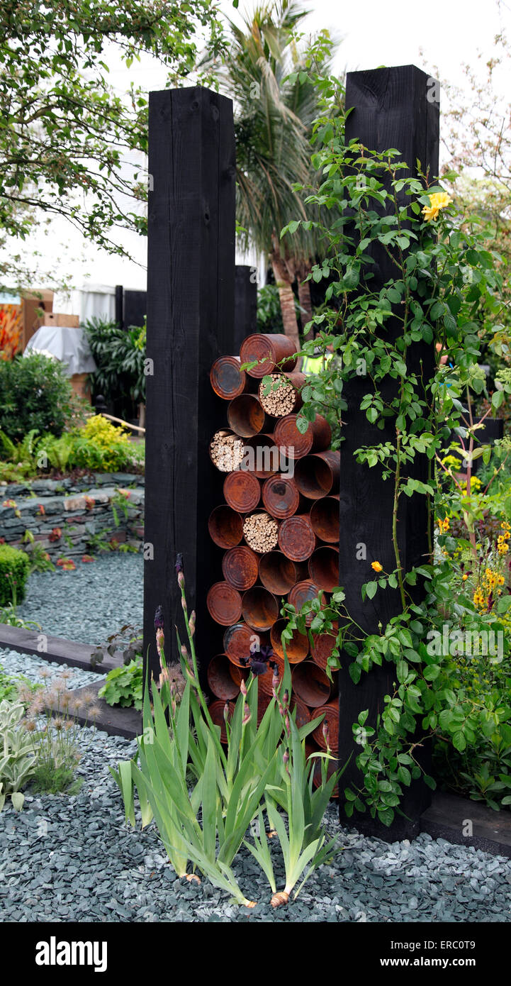 Rusty tin cans used as a decorative garden feature RHS Chelsea Flower Show 2015 Stock Photo