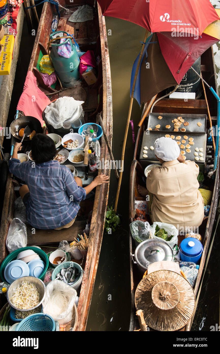 Two Thai women selling wares from their canoes at the Damnern Saduak Floating Market. Stock Photo