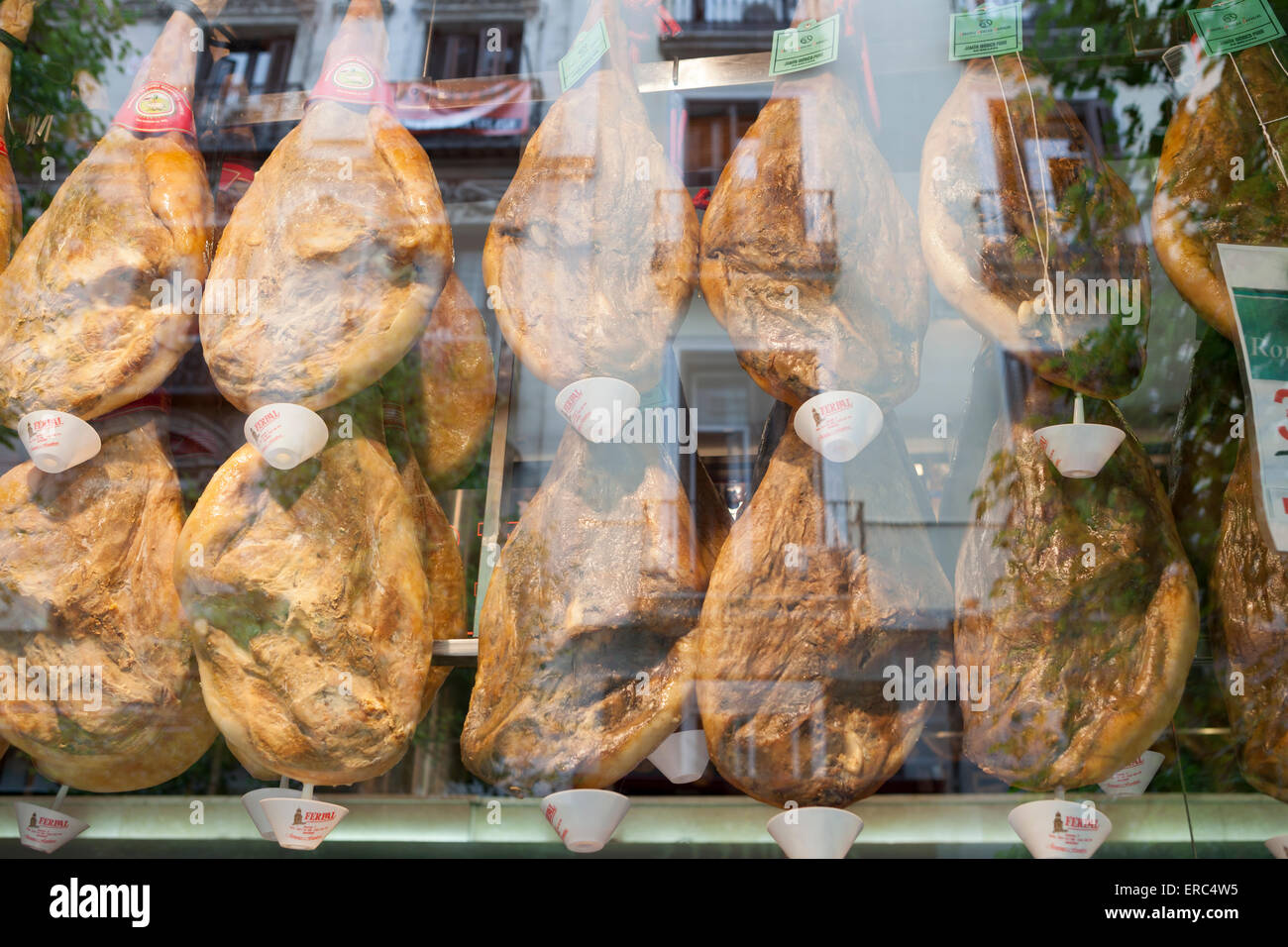 Jamon, Spanish cured ham hanging in a shop window. Madrid, Spain. Stock Photo