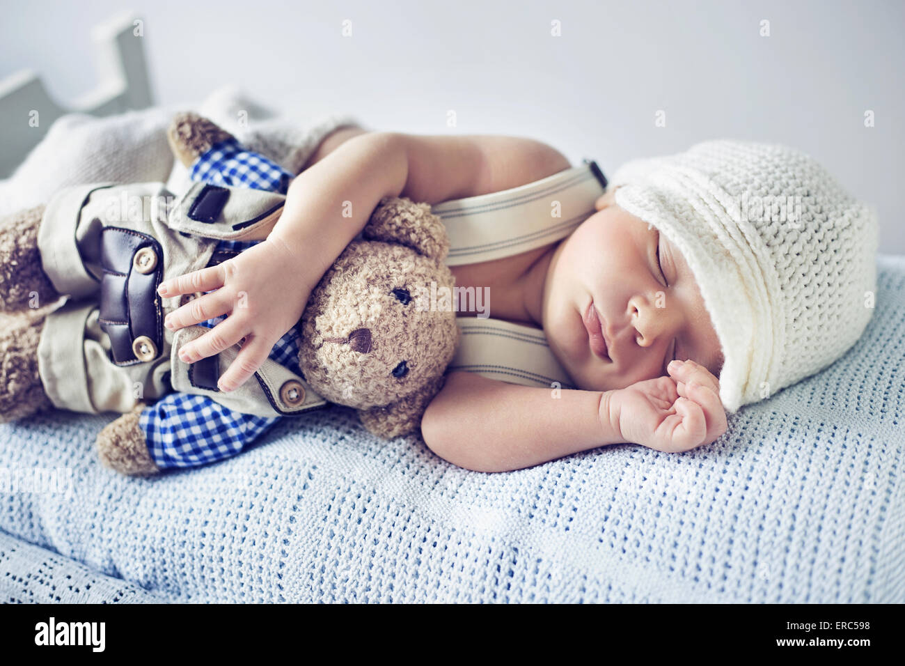 Newborn child sleeping with a teddy bear toy Stock Photo Alamy
