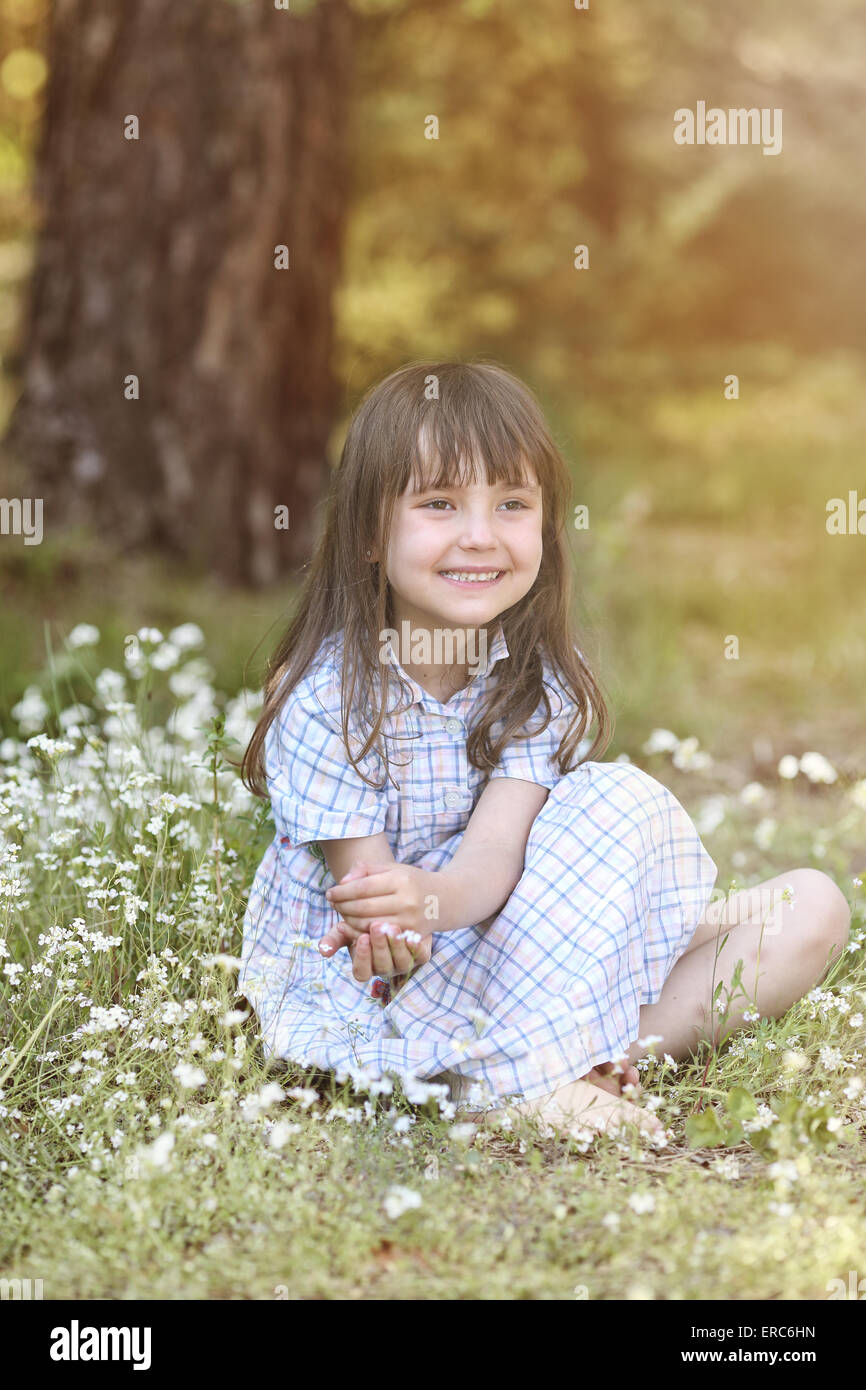 Young smiling girl on the sunny meadow Stock Photo - Alamy