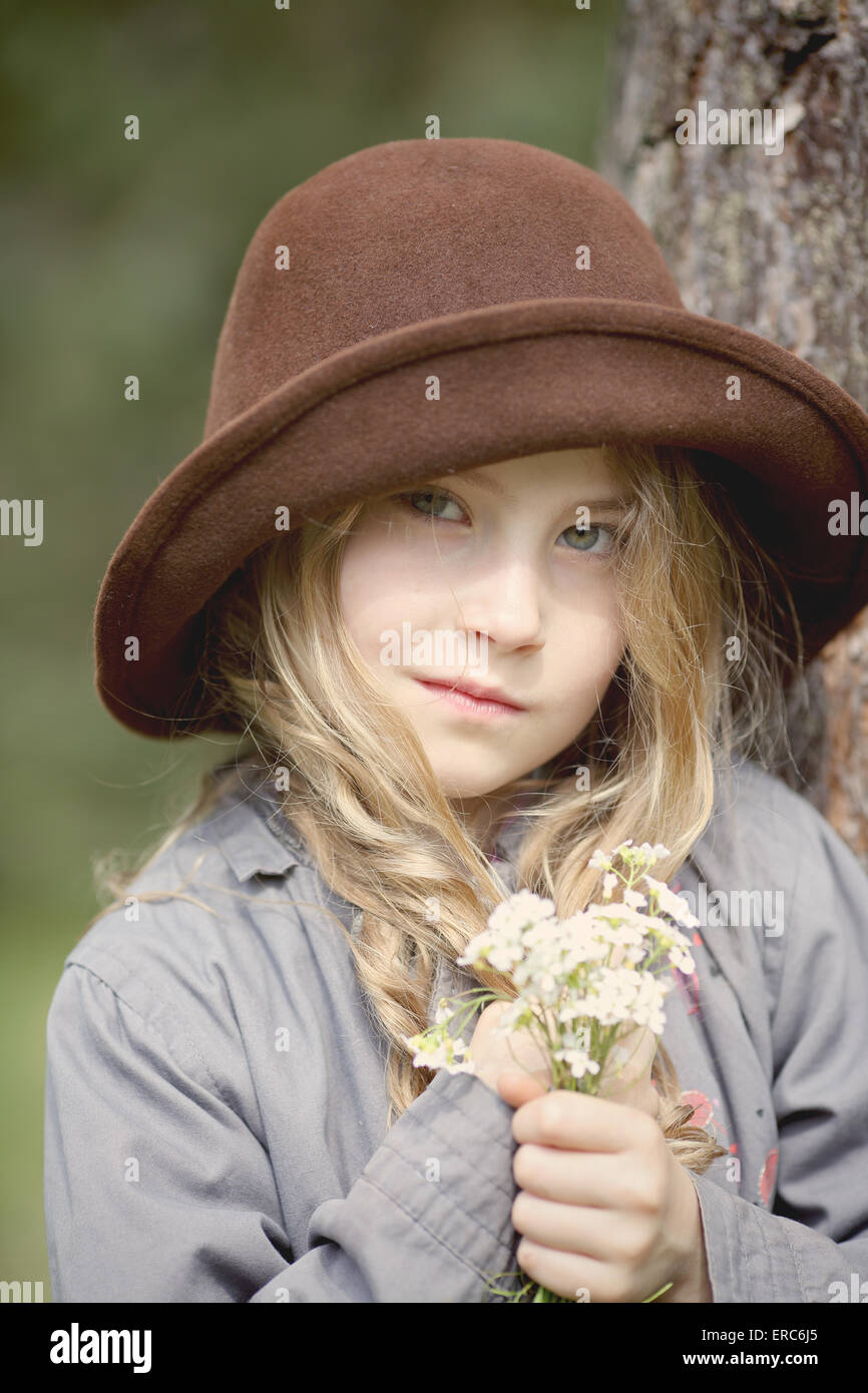 Young girl in a hat and bouquet of flowers Stock Photo - Alamy