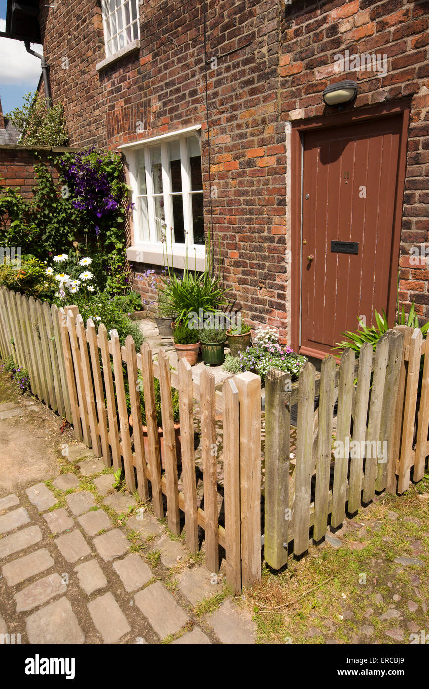 UK, England, Cheshire, Styal, Farm Fold small front garden with wooden picket fence of rented cottage Stock Photo