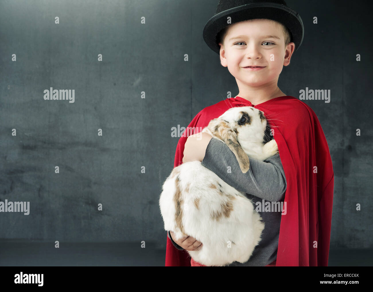 Little illusionist holding a magic bunny Stock Photo