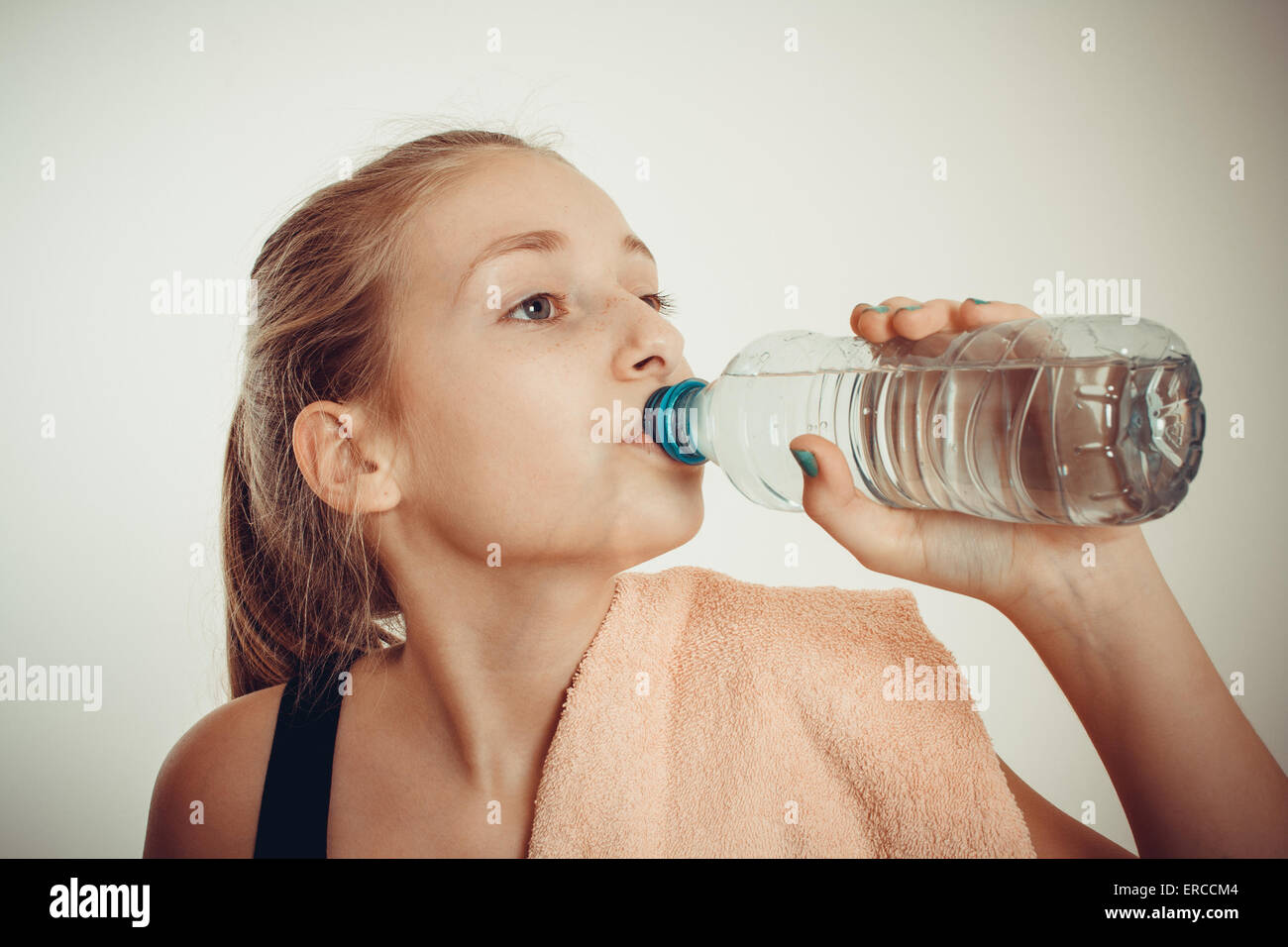 https://c8.alamy.com/comp/ERCCM4/teen-girl-drinks-bottled-water-after-exercising-vignette-toned-ERCCM4.jpg