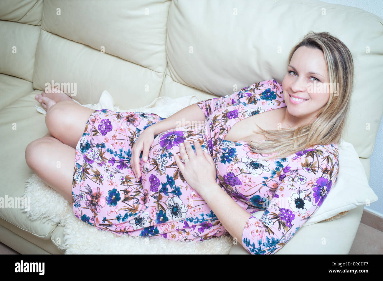 Beautiful pregnant girl lying on the couch Stock Photo Alamy