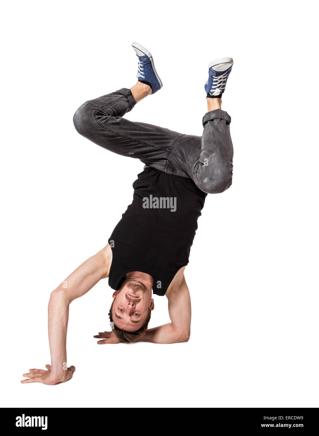 Break dancer doing one handed handstand against a white background Stock Photo