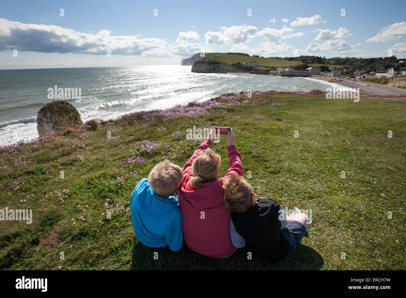 A Family enjoy the view of Freshwater Bay on the Isle of Wight Stock Photo