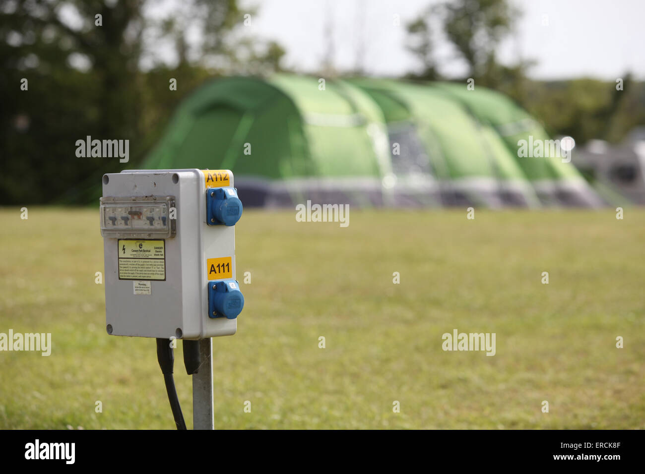 Electric hook up power point on a campsite in the UK used by caravans and tents Stock Photo