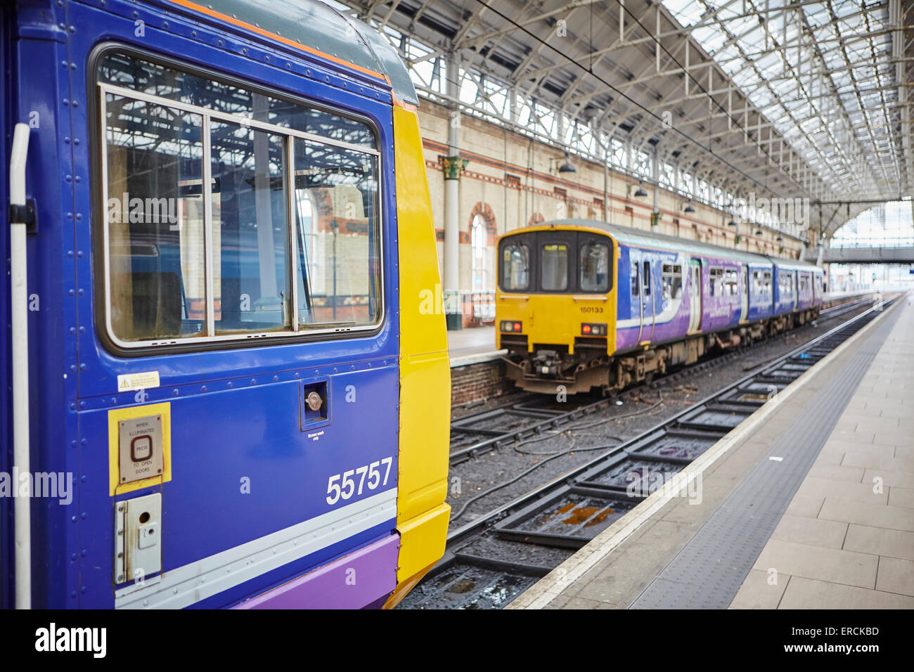 Manchester Piccadilly (left) a Norther Rail class 142 pacer and a 150 Sprinter in the company's purple livery  Railways station Stock Photo
