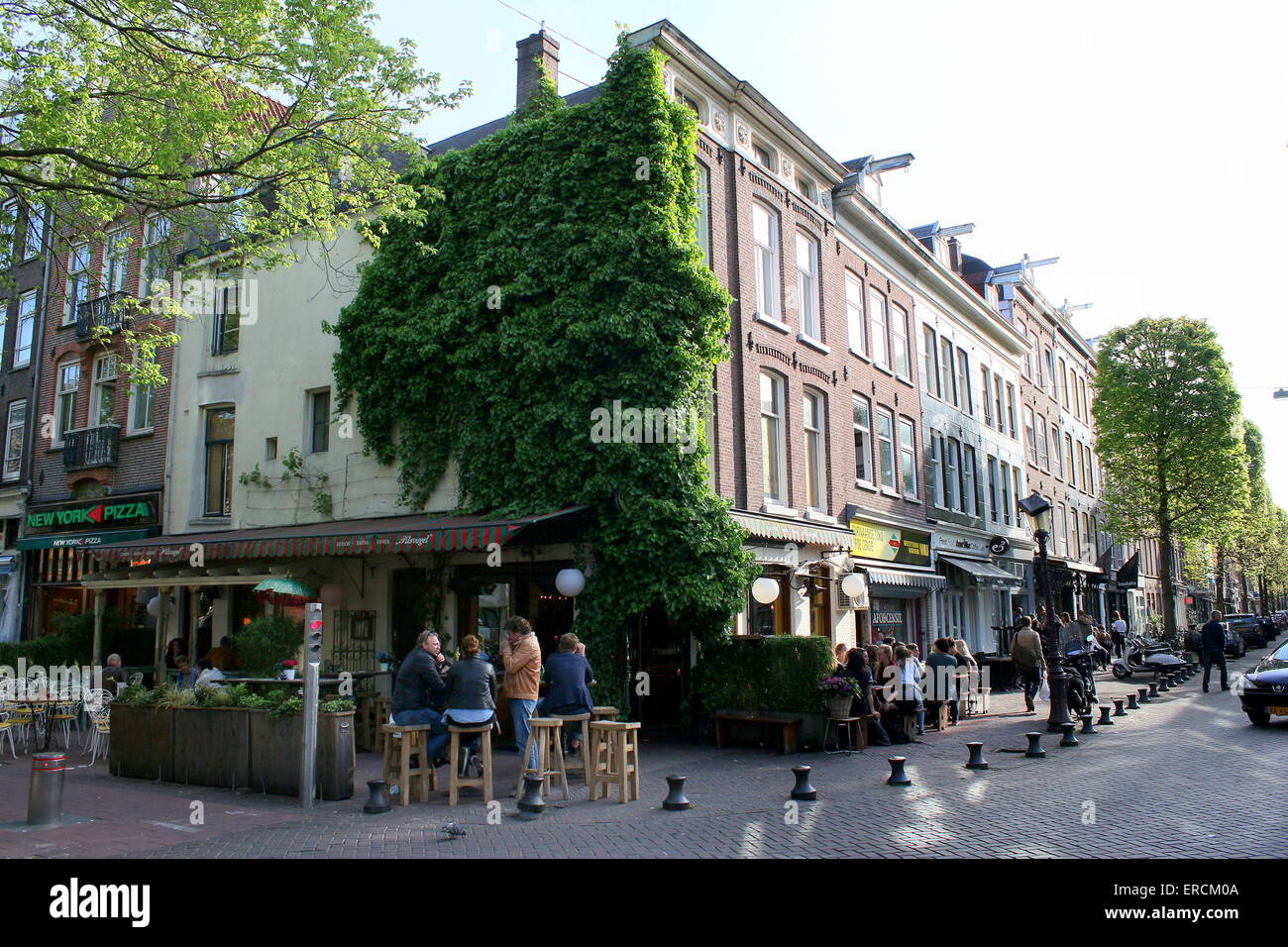 People  dining and drinking on a summer evening at scenic Gerard Douplein, de Pijp district, Amsterdam Stock Photo