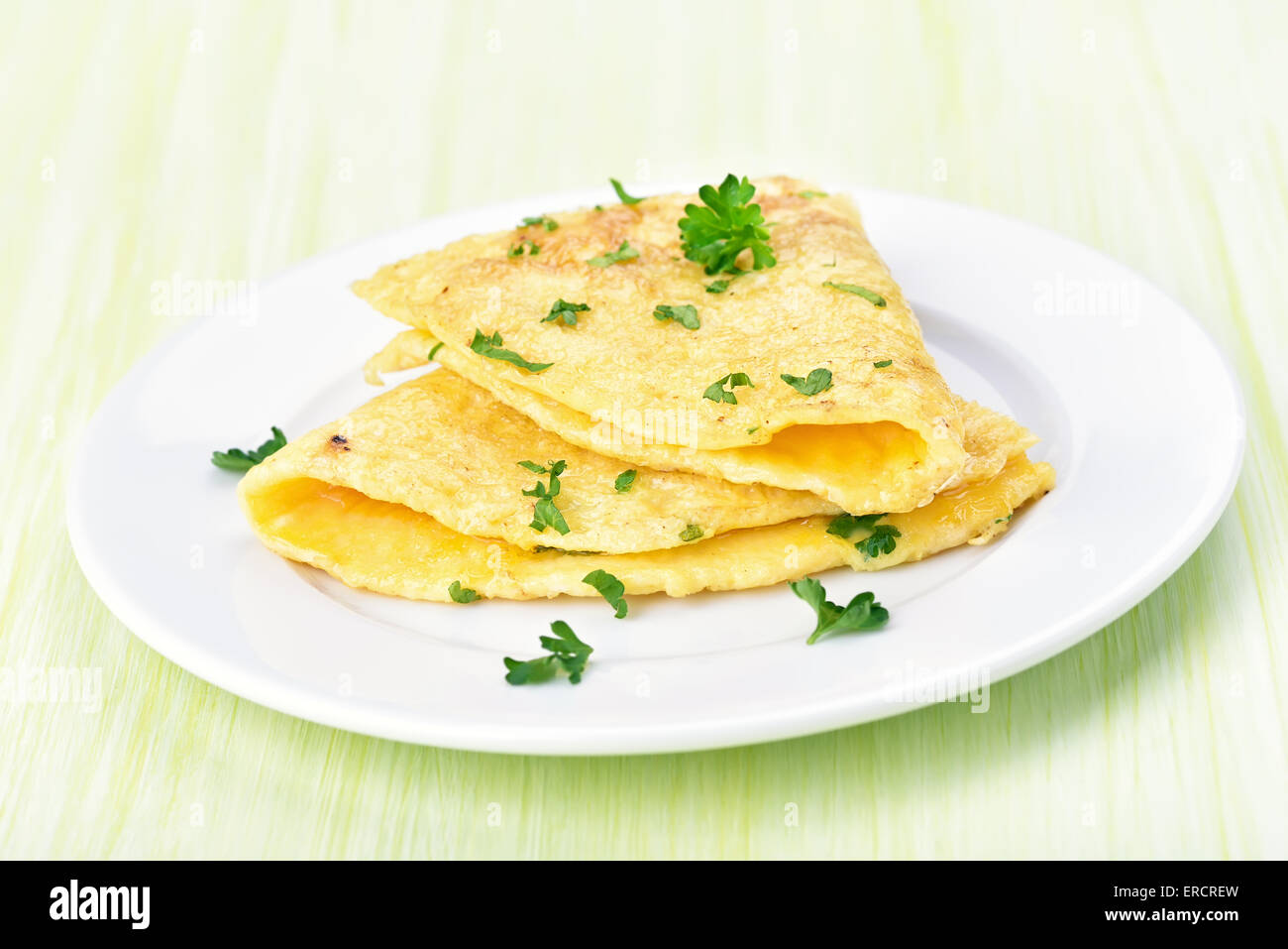 Omelette decorated parsley on white plate Stock Photo