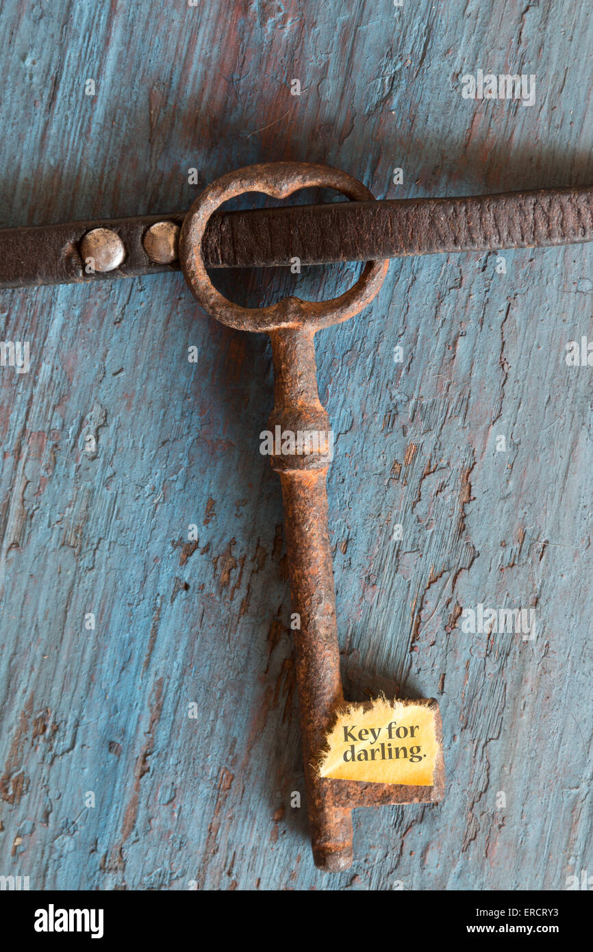 Key for darling. Concept for love, relationship, friendship and loneliness. Vintage card with old key. Stock Photo