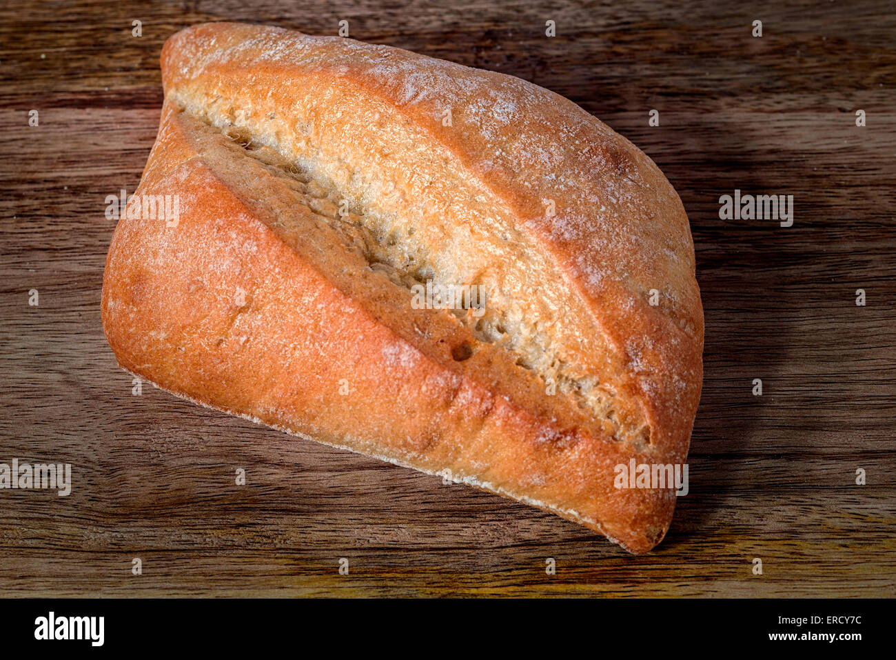 bread isolated on wooden table Stock Photo