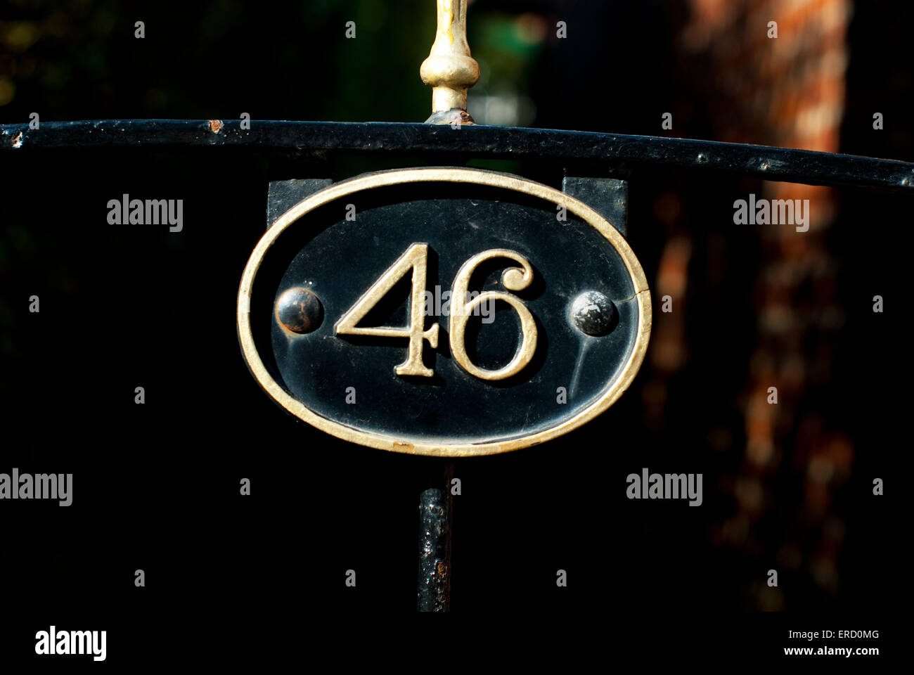 House Number 46 plaque on a wrought Iron gate Stock Photo