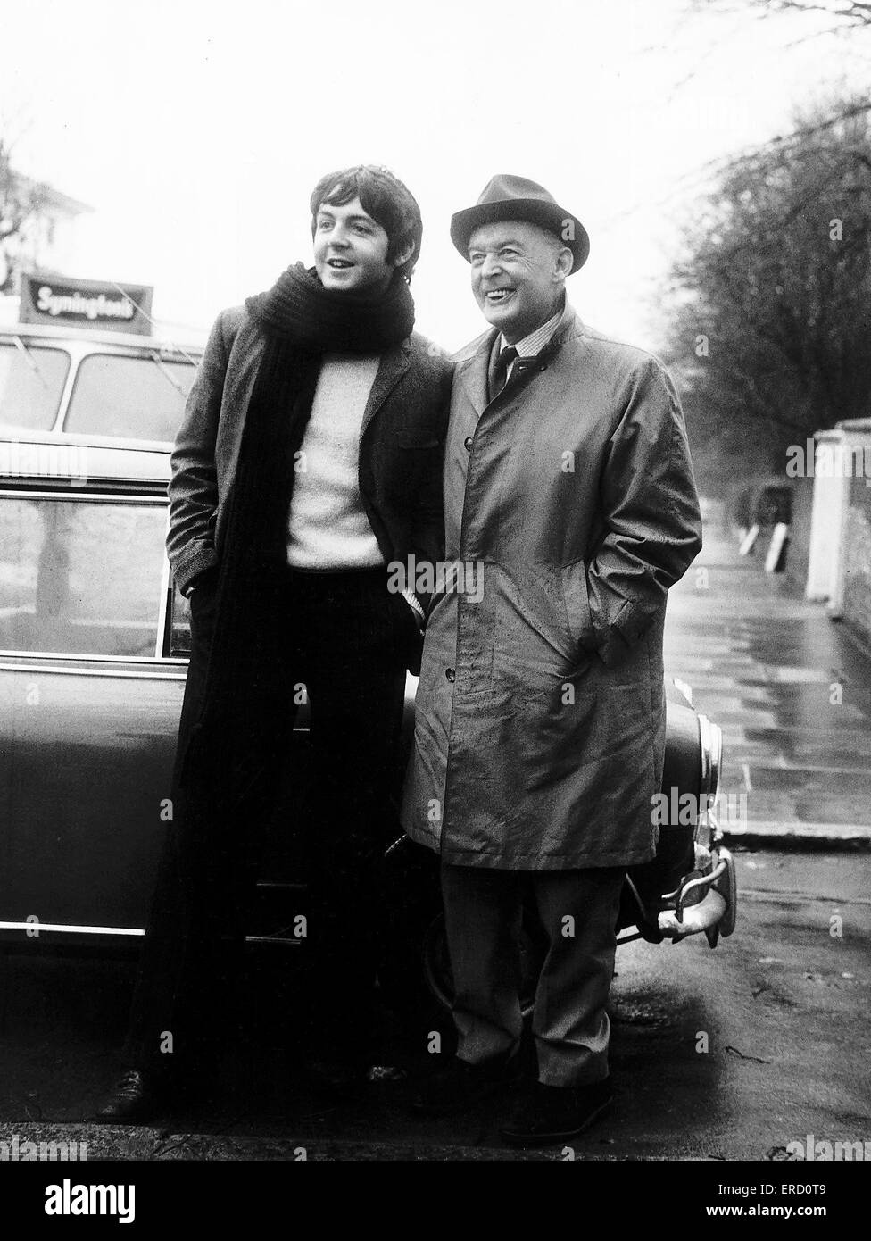 Paul McCartney, with father Jim McCartney, speaks to the press after criticism of the Beatles film 'Magical Mystery Tour' which was aired on BBC yesterday, Boxing Day 1967, pictured standing outside gates of  home in St John's Wood, London, 27th December Stock Photo