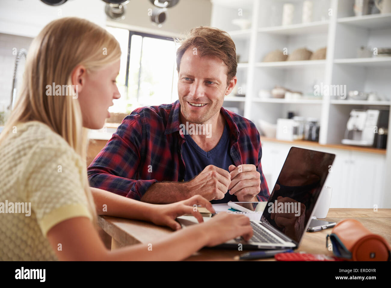 Father and daughter using laptop computer at home Stock Photo - Alamy
