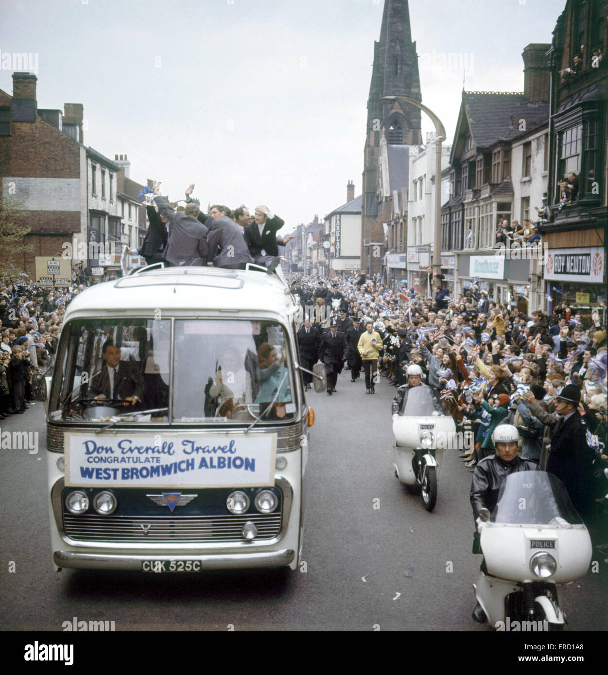 The West Bromwich Albion team are welcomed home by thousands of jubilant fans who lined the streets to see them parade the FA Cup trophy from an open top bus following their heroic victory over Everton in the Cup Final at Wembley. 18th May 1968. Stock Photo