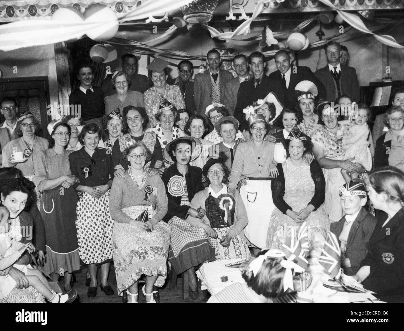 Families get together at the Stockingford Liberal Club to celebrate the Queen's coronation. Many of the party hats were give aways with Brooke Bond Tea. 2nd June 1953 Stock Photo