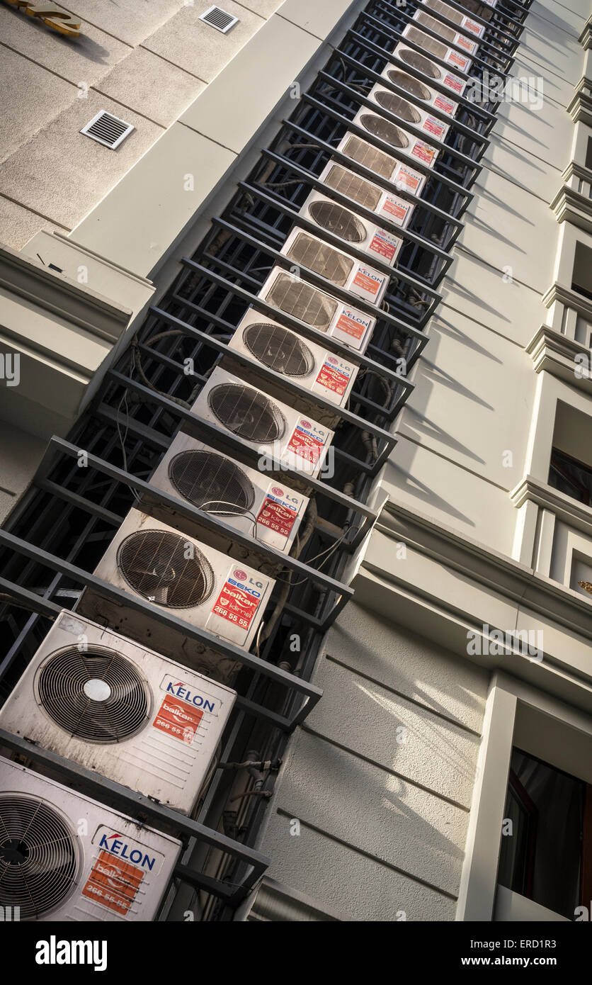 Multiple air conditioning units attached to the side of a modern hotel