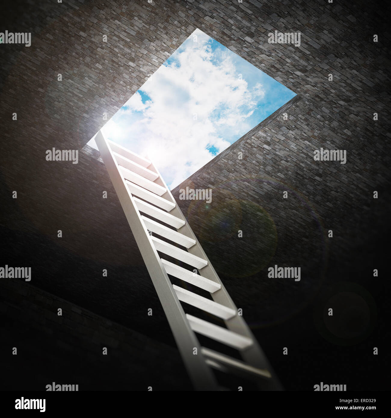 Ladder leading to the opening to the blue sky. Stock Photo