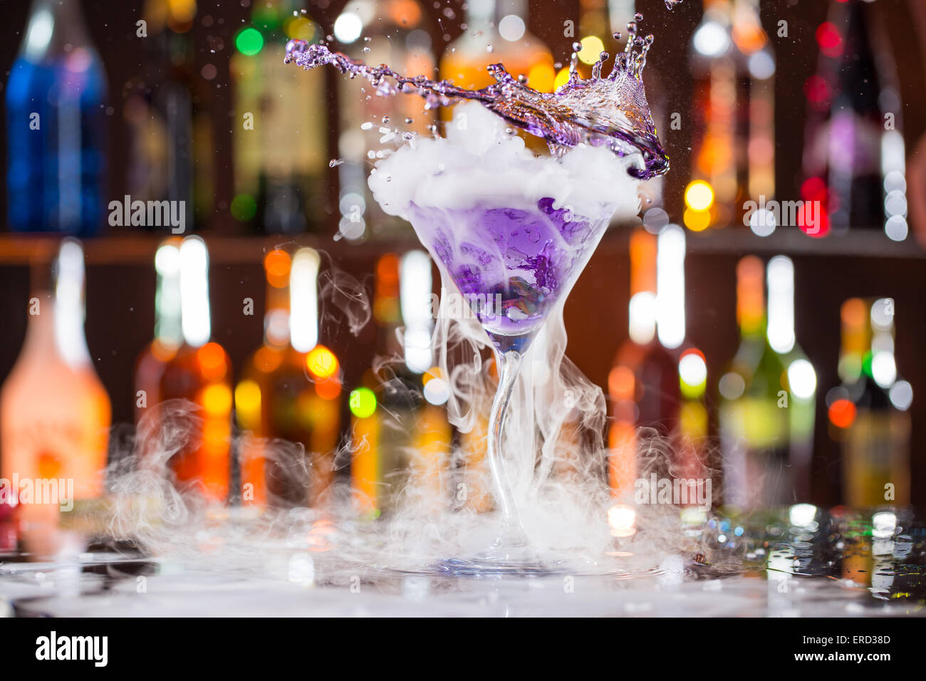 Cocktail with ice vapor on bar desk, close-up. Stock Photo