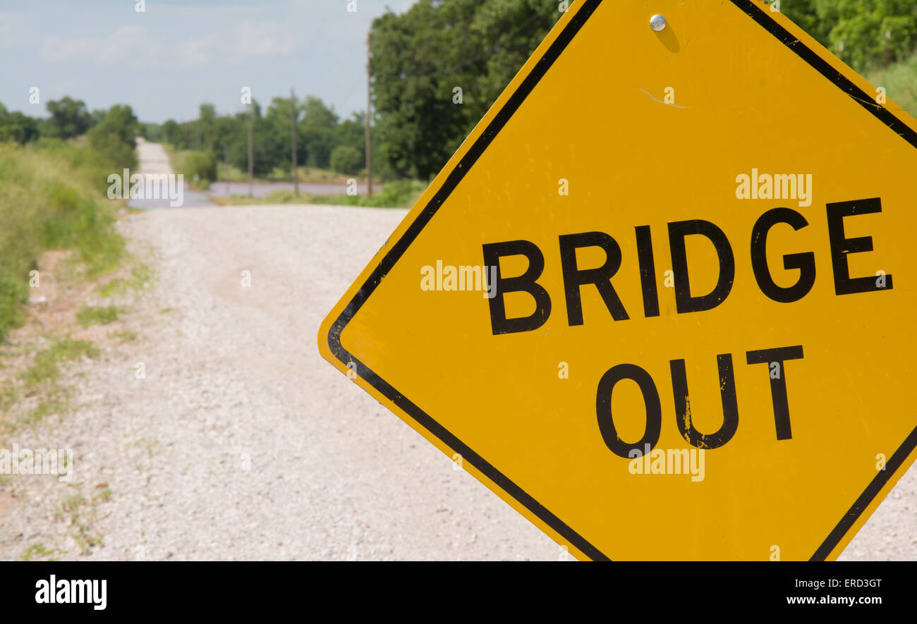 Bridge out -sign ahead of a flooding covered road warning drivers Stock Photo